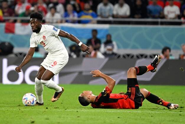 DOHA, QATAR - NOVEMBER 23 : Davies Alphonso forward of Canada & Tielemans Youri midfielder of Belgium during the FIFA World Cup, WM, Weltmeisterschaft, Fussball Qatar 2022 Groupe F match between Belgium and Canada at the Ahmad Bin Ali Stadium on November 23, 2022 in Doha, Qatar, 23 11 2022 ( Belgium v Canada - FIFA World Cup Qatar 2022 PhotoNews Panoramic 
