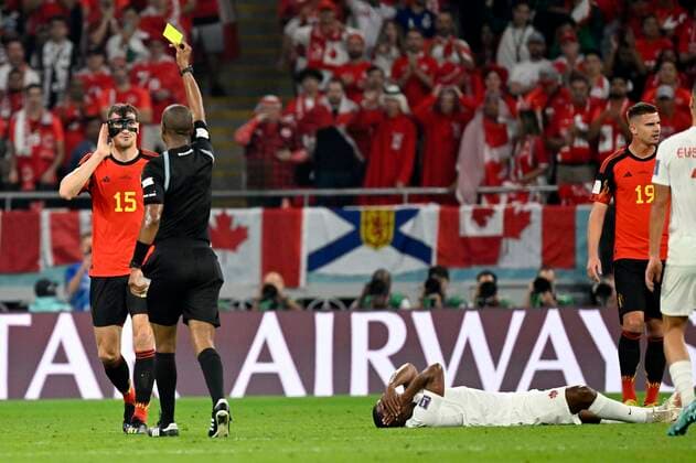 DOHA, QATAR - NOVEMBER 23 : Meunier Thomas defender of Belgium receives a yellow card from Referee SIKAZWE Janny during the FIFA World Cup, WM, Weltmeisterschaft, Fussball Qatar 2022 Groupe F match between Belgium and Canada at the Ahmad Bin Ali Stadium on November 23, 2022 in Doha, Qatar, 23 11 2022 ( Belgium v Canada - FIFA World Cup Qatar 2022 PhotoNews Panoramic 