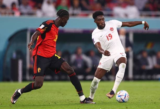 Al Rayyan, Qatar, 23rd November 2022. Amadou Onana of Belgium faces Alphonso Davies of Canada during the FIFA World Cup, WM, Weltmeisterschaft, Fussball 2022 match at Ahmad bin Ali Stadium, Al Rayyan. Picture credit should read: David Klein Sportimage EDITORIAL USE ONLY. No use with unauthorised audio, video, data, fixture lists, club league logos or live services. Online in-match use limited to 120 images, no video emulation. No use in betting, games or single club league player publications. SPI-2059-0098