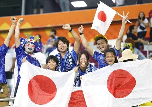 Football World Cup in Qatar Fans celebrate Japan s 2-1 victory over Germany in a World Cup Group E football match at Khalifa International Stadium in Doha, Qatar, on Nov. 23, 2022.  A14AA0001361259P 
