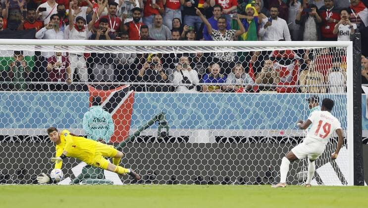 Football World Cup in Qatar Thibaut Courtois (L) of Belgium saves a penalty from Canada s Alphonso Davies in the first half of a World Cup Group F match at Ahmad Bin Ali Stadium in Al Rayyan, Qatar, on Nov. 23, 2022.  A14AA0001361309P 