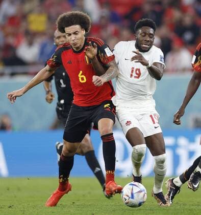 CORRECTED: Football World Cup in Qatar Belgium s Axel Witsel (L) vies for the ball with Alphonso Davies of Canada in the second half of a World Cup Group F match against Canada at Ahmad Bin Ali Stadium in Al Rayyan, Qatar, on Nov. 23, 2022.  A14AA0001361312P 
