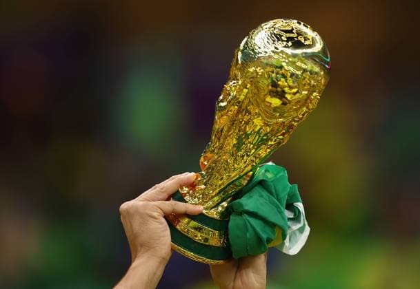 Doha, Qatar, 24th November 2022. A Brazil fans holds up a model World Cup Trophy before the FIFA World Cup, WM, Weltmeisterschaft, Fussball 2022 match at Lusail Stadium, Doha. Picture credit should read: David Klein Sportimage EDITORIAL USE ONLY. No use with unauthorised audio, video, data, fixture lists, club league logos or live services. Online in-match use limited to 120 images, no video emulation. No use in betting, games or single club league player publications. SPI-2063-0003