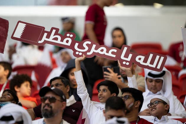 DOHA, QATAR - NOVEMBER 25: A Qatar fan holds a sign before the FIFA World Cup, WM, Weltmeisterschaft, Fussball Qatar 2022 Group A match between Qatar and Senegal at Al Thumama Stadium on November 25, 2022 in Doha, Qatar. (Photo by Sebastian Frej) WCS  Copyright: xSebastianxFrej