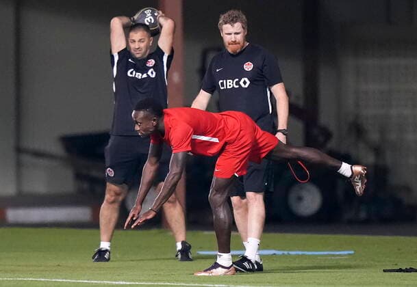 November 25, 2022, DOHA, QATAR: Canada midfielder Richie Laryea, front, stretches next to training staff during practice at the World Cup in Doha, Qatar, Friday, Nov. 25, 2022. Canada News - November 25, 2022 - ZUMAc35_ 20221125_zaf_c35_042 Copyright: xNathanxDenettex