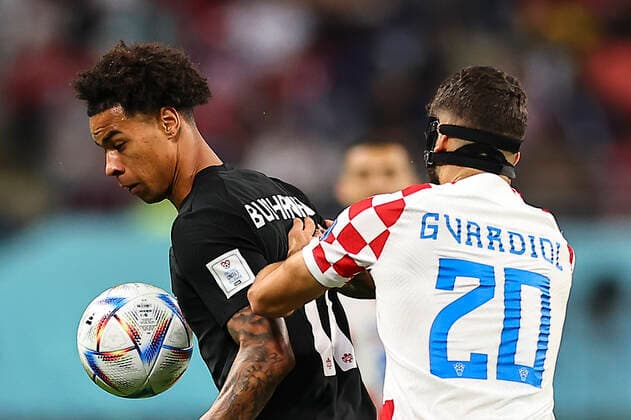 (221127) -- DOHA, Nov. 27, 2022 -- Tajon Buchanan (L) of Canada vies with Josko Gvardiol of Croatia during the Group F match between Croatia and Canada at the 2022 FIFA World Cup, WM, Weltmeisterschaft, Fussball at Khalifa International Stadium in Doha, Qatar, Nov. 27, 2022. Meng Dingbo) (SP)QATAR-DOHA-2022 WORLD CUP-GROUP F-CRO VS CAN DingxXu 