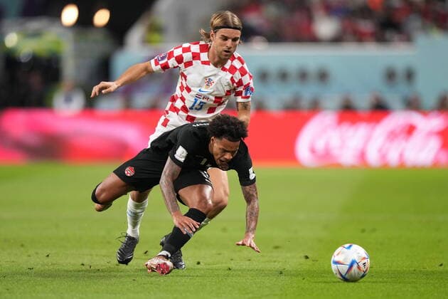 November 27, 2022, AL RAYYAN, QATAR: Canada forward Tajon Buchanan (11) goes to ground as Croatia defender Borna Sosa (19) challenges for the ball during first half group F World Cup soccer action at the Khalifa International Stadium in Al Rayyan, Qatar on Sunday, November 27, 2022. Canada News - November 27, 2022  - ZUMAc35_ 20221127_zaf_c35_030 Copyright: xNathanxDenettex