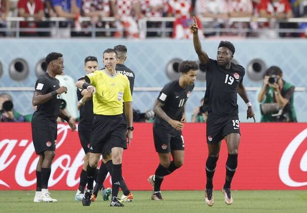 Football World Cup in Qatar Canada s Alphonso Davies (far R) celebrates after scoring the opening goal during the first half of a World Cup Group F football match against Croatia at Khalifa International Stadium in Doha, Qatar, on Nov. 27, 2022.  A14AA0001364869P 