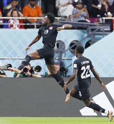 Football World Cup in Qatar Canada s Alphonso Davies (L) celebrates after scoring the opening goal during the first half of a World Cup Group F football match against Croatia at Khalifa International Stadium in Doha, Qatar, on Nov. 27, 2022.  A14AA0001364870P 