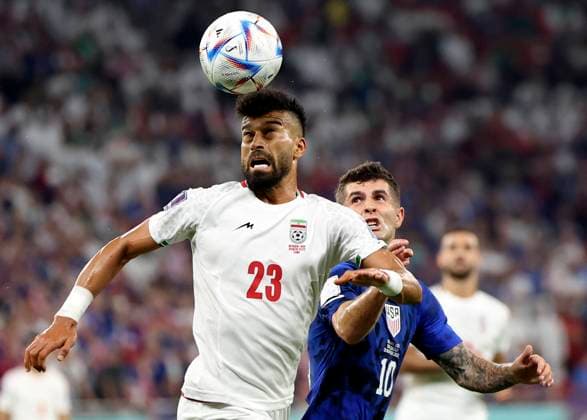 (221129) -- DOHA, Nov. 29, 2022 -- Ramin Rezaeian (L) of Iran vies with Christian Pulisic of the United States during the Group B match between Iran and the United States at the 2022 FIFA World Cup, WM, Weltmeisterschaft, Fussball at Al Thumama Stadium in Doha, Qatar, Nov. 29, 2022. ) (SP)QATAR-DOHA-2022 WORLD CUP-GROUP B-IRN VS USA CaoxCan 