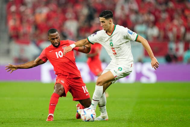 Canada v Morocco: Group F - FIFA World Cup, WM, Weltmeisterschaft, Fussball Qatar 2022 Nayef Aguerd centre-back of Morocco and West Ham United and Junior Hoilett Left Winger of Canada and Reading FC compete for the ball during the FIFA World Cup Qatar 2022 Group F match between Canada and Morocco at Al Thumama Stadium on December 1, 2022 in Doha, Qatar. Doha Qatar  Copyright: xJosexBretonx originalFilename:breton-canadavm221201_np3L5.jpg