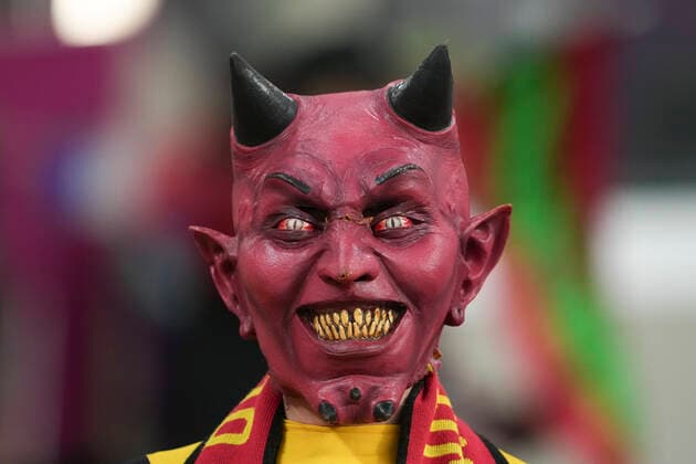 (221201) -- AL RAYYAN, Dec. 1, 2022 -- A fan of Belgium wearing a mask poses for photos before the Group F match between Croatia and Belgium at the 2022 FIFA World Cup, WM, Weltmeisterschaft, Fussball at Ahmad Bin Ali Stadium in Al Rayyan, Qatar, Dec. 1, 2022. ) (SP)QATAR-AL RAYYAN-2022 WORLD CUP-GROUP F-CRO VS BEL ZhengxHuansong 