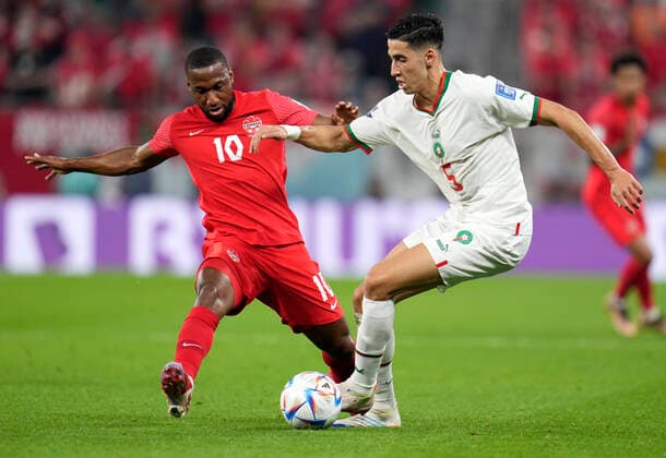 (221201) -- DOHA, Dec. 1, 2022 -- Junior Hoilett (L) of Canada vies with Nayef Aguerd of Morocco during their Group F match at the 2022 FIFA World Cup, WM, Weltmeisterschaft, Fussball at Al Thumama Stadium in Doha, Qatar, Dec. 1, 2022. ) (SP)QATAR-DOHA-2022 WORLD CUP-GROUP F-CAN VS MAR MengxDingbo 
