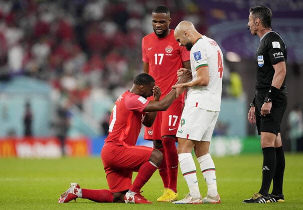 Mandatory Credit: Photo by Dave Shopland Shutterstock (13640369cz) Sofyan Amrabat of Morocco helps up Junior Hoilett of Canada. Canada v Morocco, FIFA World Cup, WM, Weltmeisterschaft, Fussball 2022, Group F, Football, Al Thumama Stadium, Doha, Qatar - 01 Dec 2022 Editorial Use Only Canada v Morocco, FIFA World Cup 2022, Group F, Football, Al Thumama Stadium, Doha, Qatar - 01 Dec 2022 Editorial Use Only  Copyright: xDavexShopland Shutterstockx 13640369cz