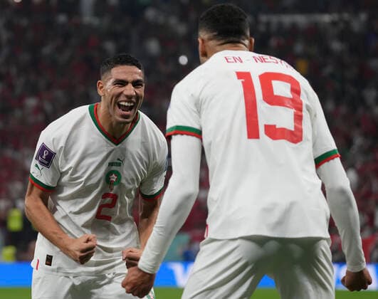 (221201) -- DOHA, Dec. 1, 2022 -- Youssef En-Nesyri (R) of Morocco celebrates with Achraf Hakimi after scoring team s second goal during the Group F match between Canada and Morocco at the 2022 FIFA World Cup, WM, Weltmeisterschaft, Fussball at Al Thumama Stadium in Doha, Qatar, Dec. 1, 2022. ) (SP)QATAR-DOHA-2022 WORLD CUP-GROUP F-CAN VS MAR LixGang 