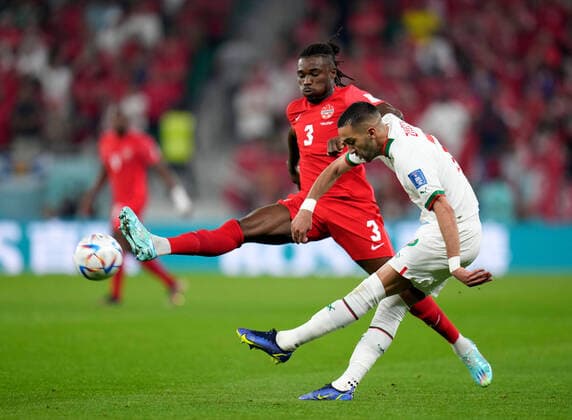 (221201) -- DOHA, Dec. 1, 2022 -- Sam Adekugbe (L) of Canada defends Noussair Mazraoui of Morocco during the Group F match between Canada and Morocco at the 2022 FIFA World Cup, WM, Weltmeisterschaft, Fussball at Al Thumama Stadium in Doha, Qatar, Dec. 1, 2022. ) (SP)QATAR-DOHA-2022 WORLD CUP-GROUP F-CAN VS MAR MengxDingbo 