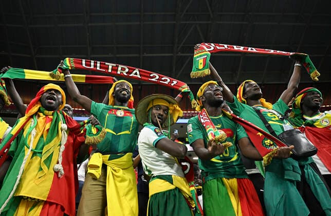 (221204) -- AL KHOR, Dec. 4, 2022 -- Fans of Senegal cheer prior to the Round of 16 match between England and Senegal of the 2022 FIFA World Cup, WM, Weltmeisterschaft, Fussball at Al Bayt Stadium in Al Khor, Qatar, Dec. 4, 2022. ) (SP)QATAR-AL KHOR-2022 WORLD CUP-ROUND OF 16-ENG VS SEN LixGa 