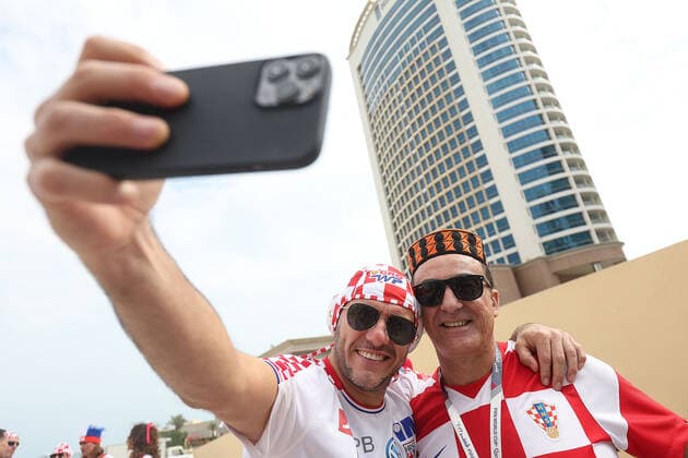PXL_QATAR 2022 _Croatian fans Good atmosphere of Croatian fans in front of the Hilton Doha hotel for support the Croatia national team, Nationalteam before the Qatar World Cup quarter-final match in against Brazil, in Doha, Qatar, on December 9, 2022. GoranxStanzl PIXSELL