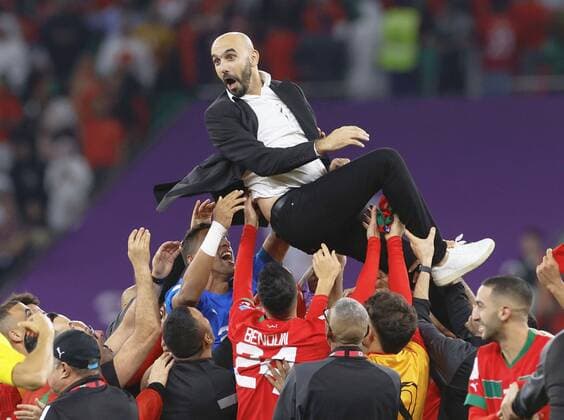 Football World Cup in Qatar Morocco head coach Walid Regragui is tossed up by his players after a 1-0 victory over Portugal in a World Cup quarterfinal football match at Al Thumama Stadium in Doha, Qatar, on Dec. 10, 2022.  A14AA0001374261P 