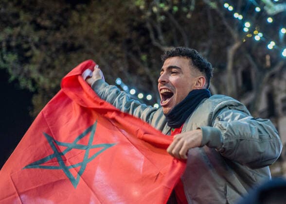 December 10, 2022, Barcelona, Spain: A Moroccan supporter holds the flag of his country as he celebrates the winning over Portugal in the 2022 FIFA World Cup, WM, Weltmeisterschaft, Fussball at Las Ramblas. The Moroccan national soccer team makes history by qualifying for the semifinals of the World Cup in Qatar. Madness breaks out in the streets of Barcelona, where the Moroccan community is one of the most numerous in the city. The supporters celebrated without incident. Barcelona Spain - ZUMAs197 20221210_zaa_s197_325 Copyright: xMarioxCollx