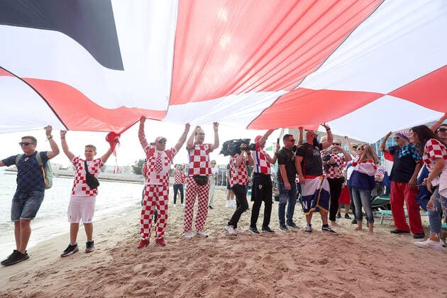 Croatia fans carry 200 meters flag Supporters of Croatia are seen prior FIFA World Cup, WM, Weltmeisterschaft, Fussball Qatar 2022 bronze medal match between Croatia and Morocco at Hilton Doha beach in Doha, Qatar on December 17, 2022. Fans carry 200 meters long flag of Croatia. GoranxStanzl PIXSELL