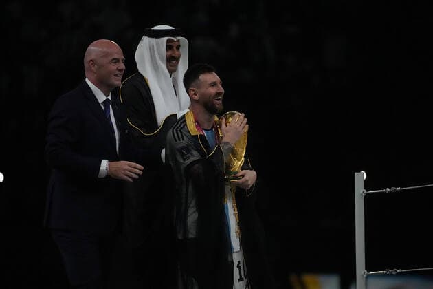 QAT, World Cup FIFA 2022, Final, Argentina vs France 18 12 2022, Lusail Iconic Stadium, Doha, QAT, World Cup FIFA 2022, Final, Argentina vs France, in picture Argentina s forward Lionel Messi receives the World Cup trophy from FIFA President Giovanni Infantino and Tamim bin Hamad Al Thani, the Emir of Qatar nordphotoxGmbHx xBratic nph00250