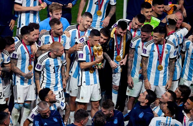 FOOTBALL World Cup 2022 Final Argentina France 18 12 2022 Argentina celebrates itself as world champion Lionel Messi and Angel Di Maria kiss the cup and celebrate the world title with their teammates