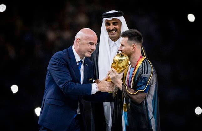 Doha, Qatar 18th Dec, 2022 Lionel Messi of Argentina carries the FIFA World Cup Qatar 2022 Winner s Trophy as Gianni Infantino, President of FIFA, and Sheikh Tamim bin Hamad Al Thani, Emir of Qatar, look on during the FIFA World Cup Qatar 2022 Final match between Argentina France Final match Argentina France World Cup 2022 in Qatar 18 12 2022