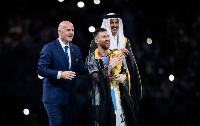 Doha, Qatar 18th Dec, 2022 Lionel Messi of Argentina carries the FIFA World Cup Qatar 2022 Winner s Trophy as Gianni Infantino, President of FIFA, and Sheikh Tamim bin Hamad Al Thani, Emir of Qatar, look on during the FIFA World Cup Qatar 2022 Final match between Argentina France Final match Argentina France World Cup 2022 in Qatar 18 12 2022