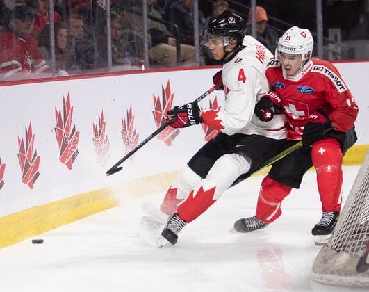 December 19, 2022, Moncton, NB, Canada: Canada s Tyson Hinds battles with Switzerland s Louis Robin during first period IIHF World Junior Hockey Championship pre-tournament hockey action in Moncton, N.B., on Monday, Dec. 19, 2022. Canada News - December 19, 2022  - ZUMAc35_ 20221219_zaf_c35_057 Copyright: xRonxWardx