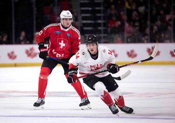 December 19, 2022, Moncton, NB, Canada: Switzerland s Lian Bichsel and Canada s Zach Dean watch as the puck clears the Canadian zone during first period IIHF World Junior Hockey Championship pre-tournament hockey action in Moncton, N.B., on Monday, Dec. 19, 2022. Canada News - December 19, 2022  - ZUMAc35_ 20221219_zaf_c35_058 Copyright: xRonxWardx