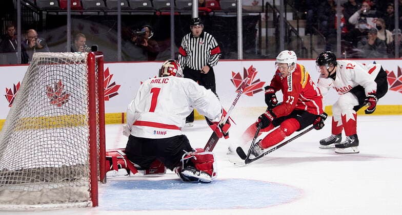 December 19, 2022, Moncton, NB, Canada: Canada goaltender Thomas Milic holds his ground as Switzerland s Attilio Biasca drives to the net while Canada s Reid Schaefer defends during first period IIHF World Junior Hockey Championship pre-tournament hockey action in Moncton, N.B., on Monday, Dec. 19, 2022. Canada News - December 19, 2022  - ZUMAc35_ 20221219_zaf_c35_060 Copyright: xRonxWardx