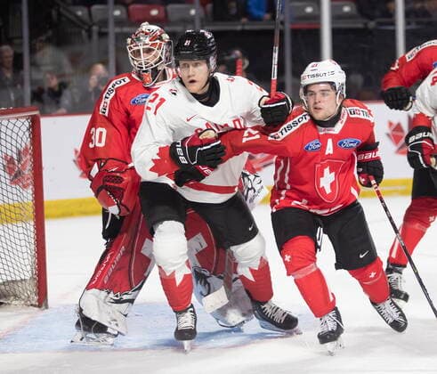 December 19, 2022, Moncton, NB, Canada: Switzerland goaltender Kevin Pasche looks for the puck as Canada™s Nathan Gaucher and Switzerland™s Dario Sidler battle in front during second period IIHF World Junior Hockey Championship pre-tournament hockey action in Moncton, N.B., on Monday, Dec. 19, 2022. Canada News - December 19, 2022  - ZUMAc35_ 20221219_zaf_c35_064 Copyright: xRonxWardx