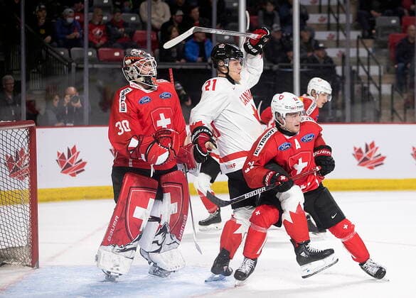 December 19, 2022, Moncton, NB, Canada: Switzerland goaltender Kevin Pasche looks for the puck as Canada™s Nathan Gaucher and Switzerland™s Dario Sidler battle in front during second period IIHF World Junior Hockey Championship pre-tournament hockey action in Moncton, N.B., on Monday, Dec. 19, 2022. Canada News - December 19, 2022  - ZUMAc35_ 20221219_zaf_c35_066 Copyright: xRonxWardx