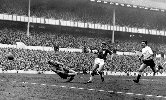 Roger Hunt Tottenham Hotspur v Liverpool Roger Hunt scores his club s first goal despite a desperate effort by the Spurs goalkeeper Hollowbread and right back Ron Henry. 27th March 1964. Great Britain  Copyright: xTopFotox 0273899