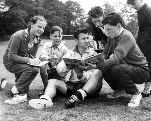 Bryan Douglas Bryan Douglas, the Blackburn and England forward, signs autographs while changing his boots at Roehampton during a World Cup training session. 29th May 1958 Great Britain  Copyright: xTopFotox 0518706