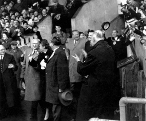 Manchester United, ManU Manchester United chairman, Harold Hardman leads the group of thirty one doctors and nurses from Munich s Rechts der Isar hospital out through the applauding crowd on to the ground prior to United s match. In a ceremony before the game, the party was publicly thanked for their work in tending to the injured in last month s air crash. In centre (side face) is Dr Georg Maurer, 49 year old surgeon and his wife. 8th March 1958 Great Britain  Copyright: xTopFotox 0549696