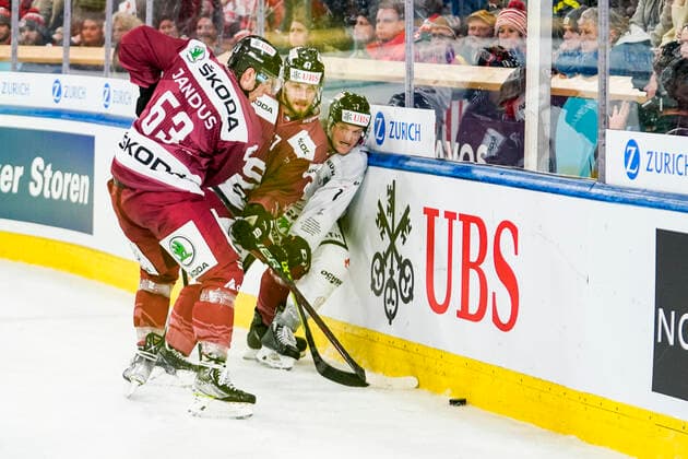 DAVOS, SWITZERLAND DECEMBER 26 Daniel Carr of Team Canada against Martin Jandus of Sparta Prague L and Jan Buchtele of Sparta Prague C during the match between HC Sparta Praha and Team Canada at Hockey Club Davos on December 26, 2022 in Davos, Switzerland Davos Graubunden Switzerland  Copyright: xJustPictures.ch JarixPestelaccix