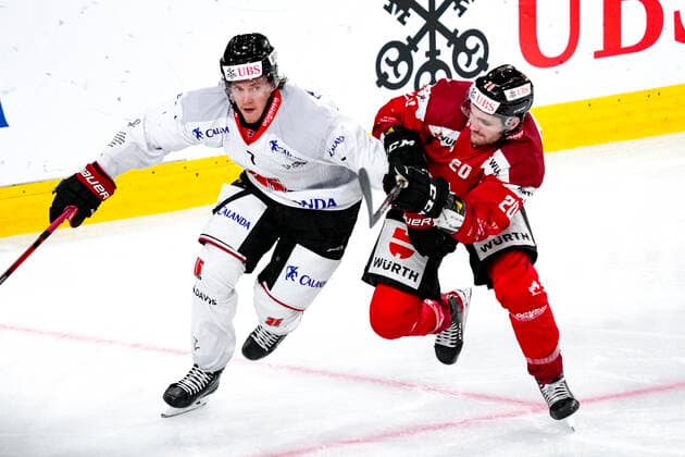 DAVOS, SWITZERLAND DECEMBER 29 Marcus Hardegrd of Örebro HK L against Kristopher Bennett of Team Canada R during the match between Orebro HK and Team Canada at Eisstadion Davos on December 28, 2022 in Davos, Switzerland Davos Graubunden Switzerland  Copyright: xJustPictures.ch JarixPestelaccix