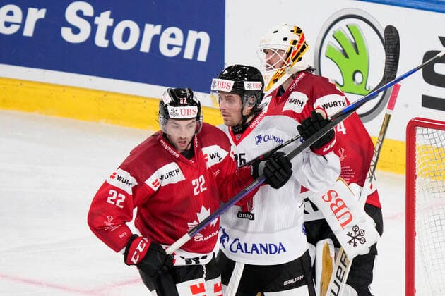 DAVOS, SWITZERLAND DECEMBER 29 Mathias Brome of Örebro HK C fight for a position into the slot against Alan Quine of Team Canada L during the match between Orebro HK and Team Canada at Eisstadion Davos on December 28, 2022 in Davos, Switzerland Davos Graubunden Switzerland  Copyright: xJustPictures.ch JarixPestelaccix
