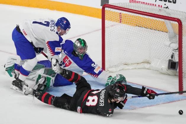 January 2, 2023, Halifax, NS, Canada: Canada s Caedan Bankier, right, stretches for a loose puck in front of Slovakia s goaltender Jan Korec, centre, and Simon Nemec during first period IIHF World Junior Hockey Championship quarterfinal action in Halifax, Monday, Jan. 2, 2023. Caedan Bankier, Jan Korec, Simon Nemec  - ZUMAc35_ 20230102_zaf_c35_104 Copyright: xDarrenxCalabresex