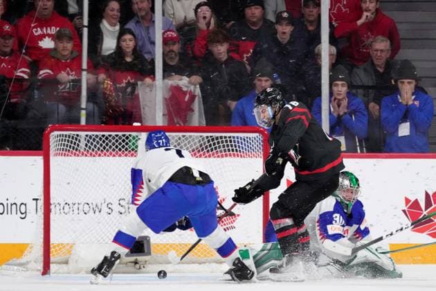January 2, 2023, Halifax, NS, Canada: Canada s Connor Bedard, centre, scores the game-winning goal past Slovakia s goaltender Jan Korec, right, and Simon Nemec during overtime of IIHF World Junior Hockey Championship quarterfinal action in Halifax, Monday, Jan. 2, 2023. Connor Bedard, Jan Korec, Simon Nemec  - ZUMAc35_ 20230102_zaf_c35_127 Copyright: xDarrenxCalabresex