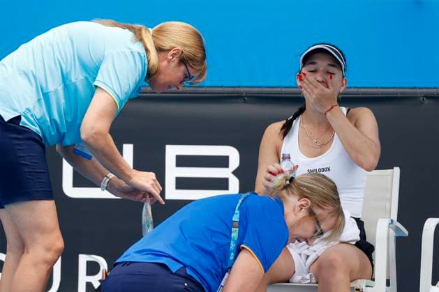 Eva Lys is treated for wrist injury,takes a tablet,physiotherapist,doctor,Australian Open 2023,Melbourne Park,Melbourne,Victoria,Australia Copyright: xJuergenxHasenkopfx
