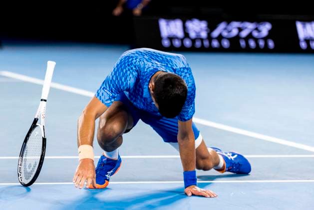 MELBOURNE, VIC - JANUARY 21: Novak Djokovic of Serbia falls to the court surface after a period of play during Round 3 of the 2023 Australian Open on January 21 2023, at Melbourne Park in Melbourne, Australia. (Photo by Jason Heidrich Icon Sportswire) TENNIS: JAN 21 Australian Open Icon230121173