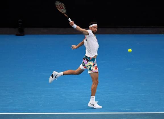 (230121) -- MELBOURNE, Jan. 21, 2023 -- Grigor Dimitrov of Bulgaria hits a return during the men s singles third round match against Novak Djokovic of Serbia at Australian Open tennis tournament in Melbourne, Australia, on Jan. 21, 2023. ) (SP)AUSTRALIA-MELBOURNE-TENNIS-AUSTRALIAN OPEN-DAY 6 GuoxLei 