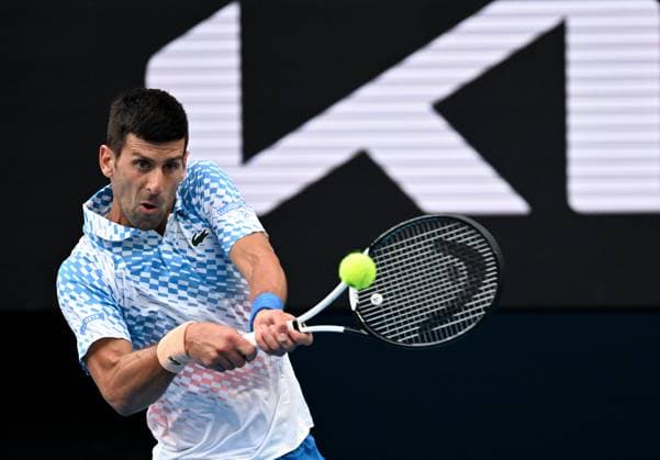 (230121) -- MELBOURNE, Jan. 21, 2023 -- Novak Djokovic of Serbia hits a return during the men s singles third round match against Grigor Dimitrov of Bulgaria at Australian Open tennis tournament in Melbourne, Australia, on Jan. 21, 2023. ) (SP)AUSTRALIA-MELBOURNE-TENNIS-AUSTRALIAN OPEN-DAY 6 GuoxLei 