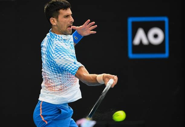 (230121) -- MELBOURNE, Jan. 21, 2023 -- Novak Djokovic of Serbia hits a return during the men s singles third round match against Grigor Dimitrov of Bulgaria at Australian Open tennis tournament in Melbourne, Australia, on Jan. 21, 2023. ) (SP)AUSTRALIA-MELBOURNE-TENNIS-AUSTRALIAN OPEN-DAY 6 GuoxLei 