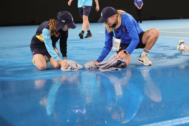 Rain delay as staff mop up the water before roof closure in the match between Elena Rybakina of Kazakistan and Jelena Ostapenko of Latvia during the Quarter Final, Day 9 at the Australian Open Tennis 2023 at Rod Laver Arena, Melbourne, Australia on 24 January 2023. Copyright: xPeterxDovganx 34781917