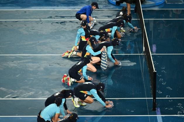 Mandatory Credit: Photo by James Gourley Shutterstock (13729783at) Ballkids clear the court after rain on the court stops play between Jelena Ostapenko and Elena Rybakina in their Quarter Final Match Australian Open, Day Nine, Tennis, Melbourne Park, Melbourne, Australia - 24 Jan 2023 Australian Open, Day Nine, Tennis, Melbourne Park, Melbourne, Australia - 24 Jan 2023 Copyright: xJamesxGourley Shutterstockx 13729783at