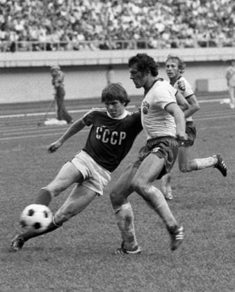 Montreal, Canada. Athletes Alexander Minayev (USSR) and Wolfram Loewe (German Democratic Republic) (L-R) compete in the semi-final soccer match USSR vs GDR at the Olympic Stadium during the 1976 Summer Olympics. The East German team claims a 1:2 win. Viktor Budan, Yashar Khalilov TASS  17408116